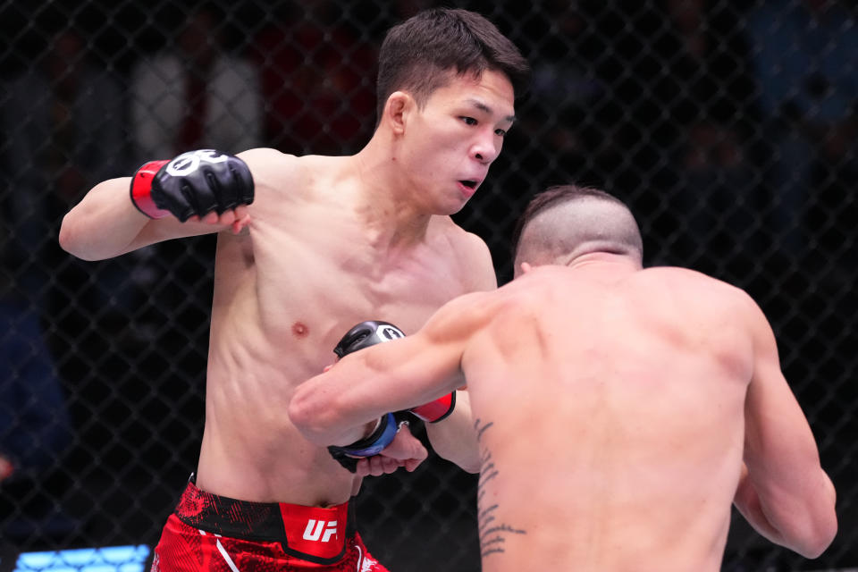 LAS VEGAS, NEVADA – DECEMBER 09: (L-R) HyunSung Park of South Korea punches Shannon Ross of <a class="link " href="https://sports.yahoo.com/soccer/teams/australia/" data-i13n="sec:content-canvas;subsec:anchor_text;elm:context_link" data-ylk="slk:Australia;sec:content-canvas;subsec:anchor_text;elm:context_link;itc:0">Australia</a> in a flyweight fight during the UFC Fight Night event at UFC APEX on December 09, 2023 in Las Vegas, Nevada. (Photo by Jeff Bottari/Zuffa LLC via Getty Images)