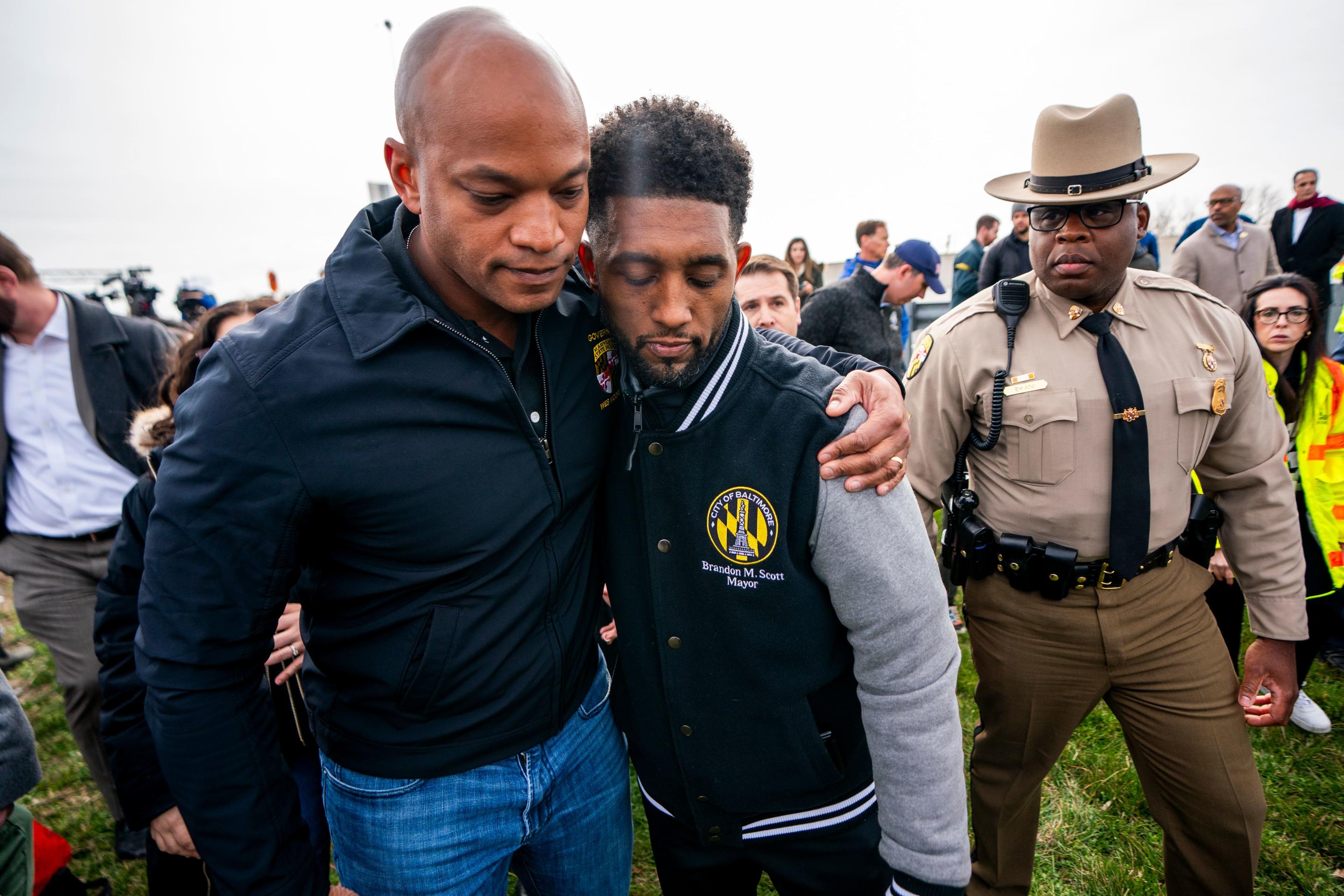 Maryland Governor Wes Moore (L) and Baltimore Mayor Brandon Scott (C) react following a press conference at the scene. (Shawn Thew/EPA-EFE/Shutterstock)