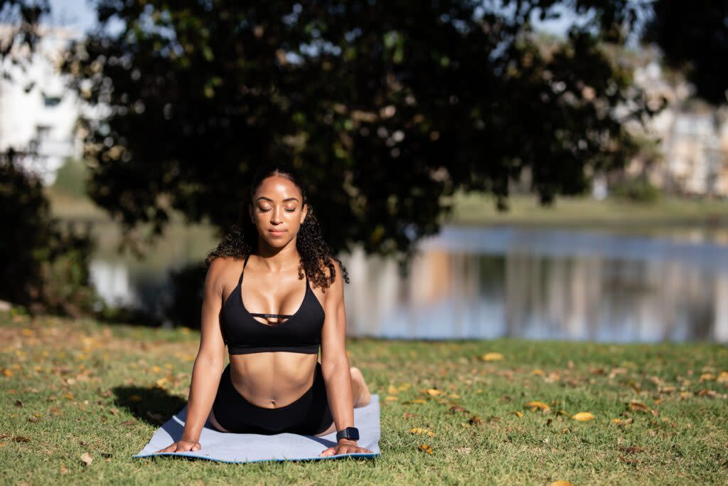 woman in black sports bra working out in a park
