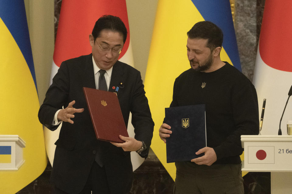 Japanese Prime Minister Fumio Kishida and Ukrainian President Volodymyr Zelenskyy, right, talk after the signing of joint documents in Kyiv, Ukraine, Tuesday, March 21, 2023. (AP Photo/Efrem Lukatsky)