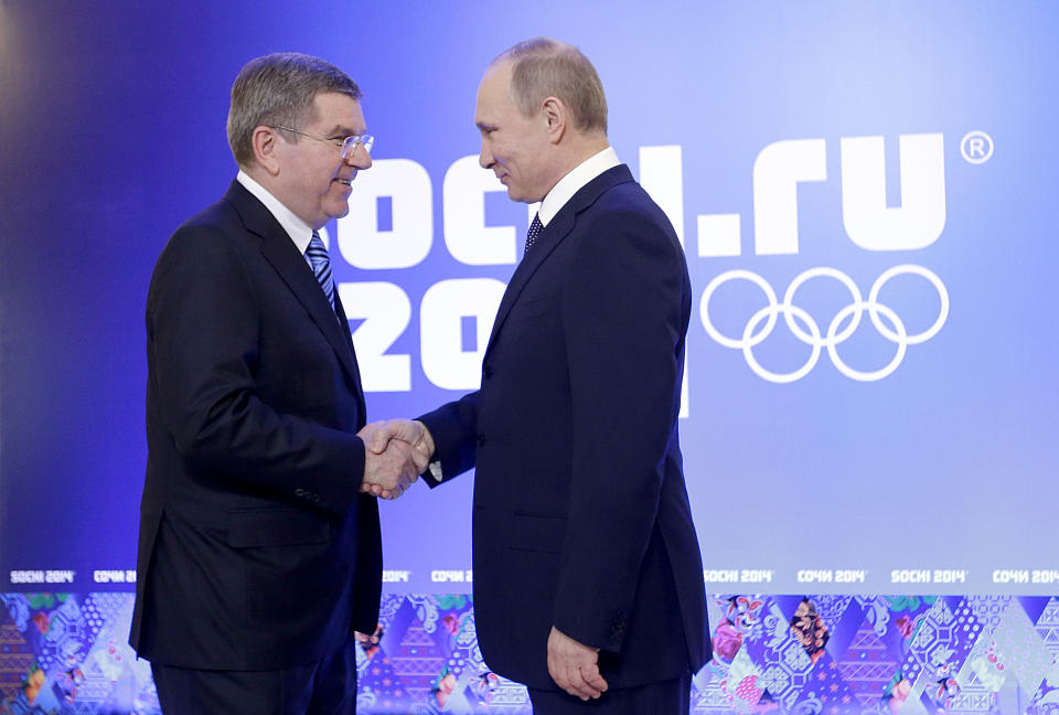 Russian President Vladimir Putin, right, greets International Olympic Committee President Thomas Bach at an event welcoming IOC members ahead of the upcoming 2014 Winter Olympics at the Rus Hotel, Tuesday, Feb. 4, 2014, in Sochi, Russia. (AP Photo/David Goldman)