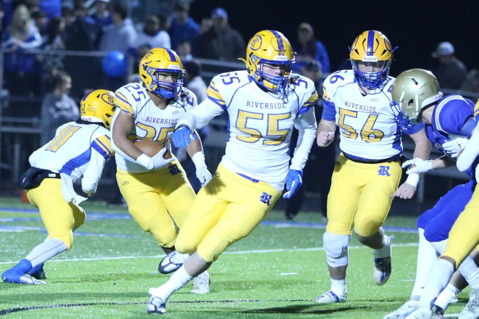 Riverside #25 Desmond Thomas runs the ball while #55 Ty Hernandez and #56 Jeb Graves provide protection Friday 11-25-22 in the Class 2A State Semi-finals held at Huntingdon, TN