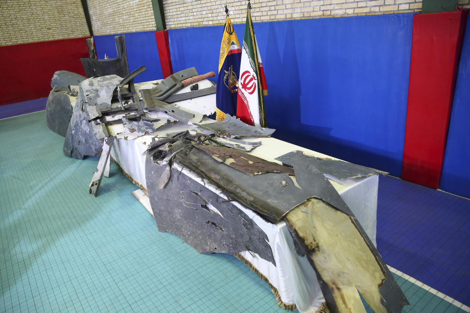 FILE - In this Friday, June 21, 2019 file photo, debris from what Iran's Revolutionary Guard aerospace division describes as the U.S. drone which was shot down on Thursday is displayed in Tehran, Iran. A year after President Trump’s unilateral withdrawal from the 2015 deal, the U.S. and Iran are already locked in a volatile standoff. Last week, Iran shot down a U.S. military drone, saying it violated Iranian airspace, though Washington said it was above international waters. (Meghdad Madadi/ Tasnim News Agency via AP, file)
