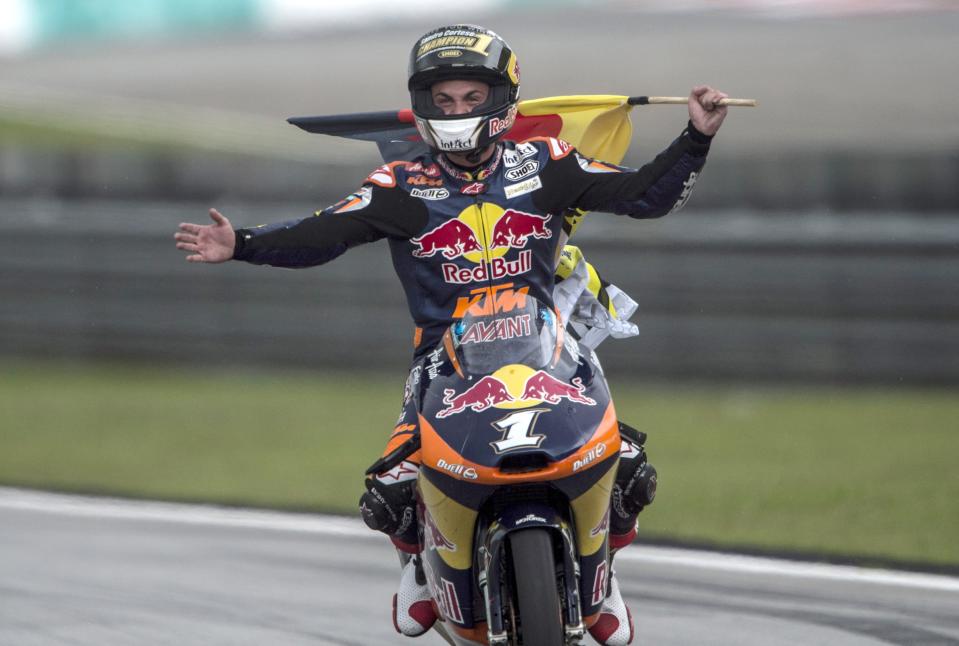 KUALA LUMPUR, MALAYSIA - OCTOBER 21: Sandro Cortese of Germany and Red Bull KTM Ajo celebrates with the flag after winning the Moto3 race, sealing victory in the Moto3 Championship, during the MotoGP Of Malaysia at Sepang Circuit on October 21, 2012 in Kuala Lumpur, Malaysia. (Photo by Mirco Lazzari gp/Getty Images)