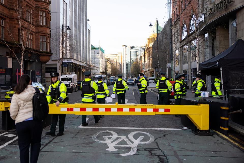 Police officers guard the entrance to the Grand Central Hotel in Belfast (EPA)