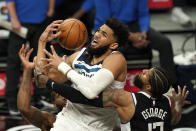 Minnesota Timberwolves center Karl-Anthony Towns, center, has the ball knocked from his hands by Los Angeles Clippers guard Paul George, right, as forward Kawhi Leonard defends during the second half of an NBA basketball game Sunday, April 18, 2021, in Los Angeles. (AP Photo/Mark J. Terrill)