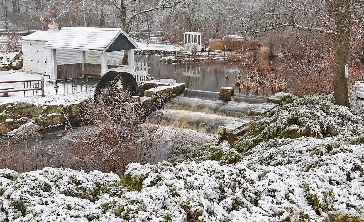 Light snow covers Veterans Park in Marshfield, through which the South River flows, on Tuesday, Feb. 13, 2024.