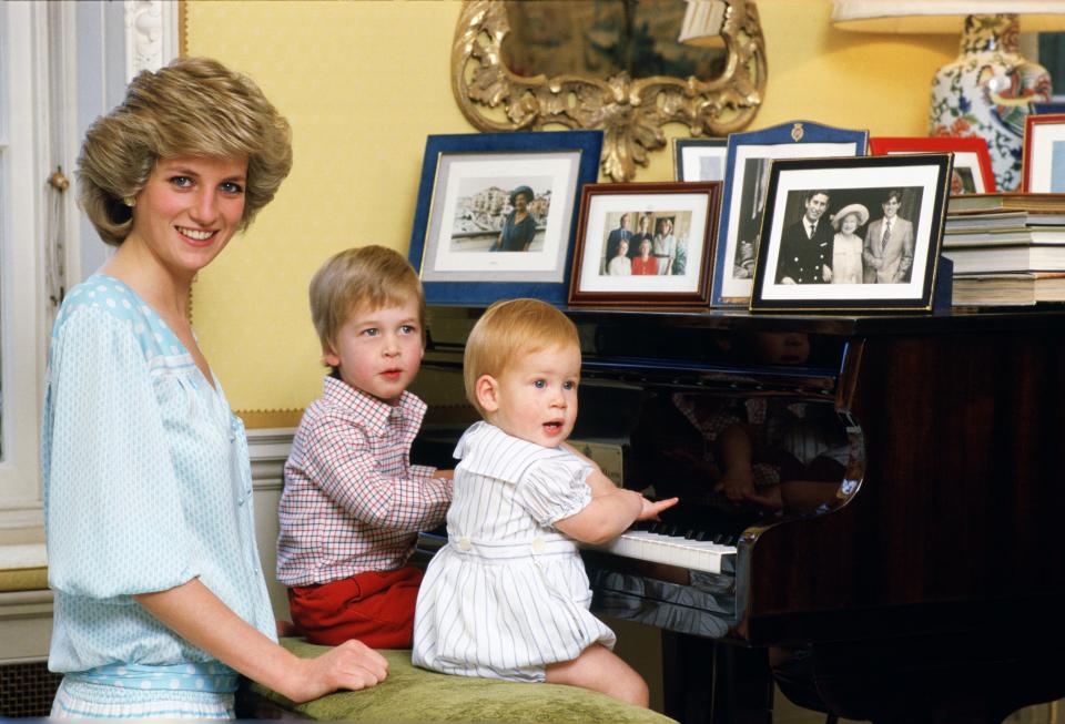 Diana, Princess of Wales with her sons, Prince William and Prince Harry, at the piano in Kensington Palace.