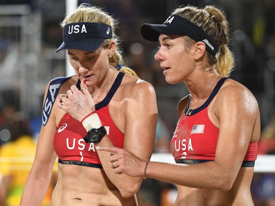 Kerri Walsh-Jennings and April Ross talk during match at the Rio Olympics.