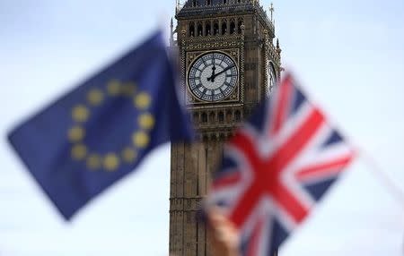 Participants hold a British Union flag and an EU flag during a pro-EU referendum event at Parliament Square in London, Britain June 19, 2016. REUTERS/Neil Hall/File Photo