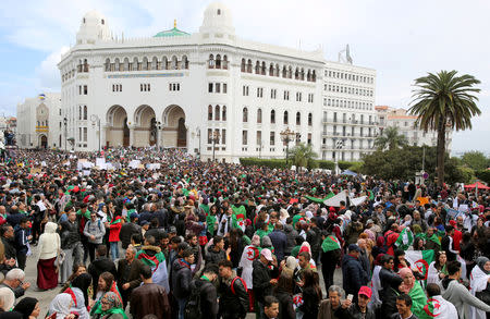 FILE PHOTO: People carry national flags and banners during a protest calling on President Abdelaziz Bouteflika to quit, in Algiers, Algeria March 19, 2019. REUTERS/Ramzi Boudina/File Photo