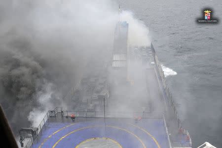 The car ferry Norman Atlantic burns in waters off Greece December 28, 2014 in this handout photo provided by Marina Militare. Italian and Greek helicopter crews prepared to work through the night to airlift passengers in pairs off a burning ferry adrift in the Adriatic Sea, battling darkness and bad weather that hampered rescue efforts by other ships throughout Sunday. REUTERS/Marina Militare/Handout via Reuters