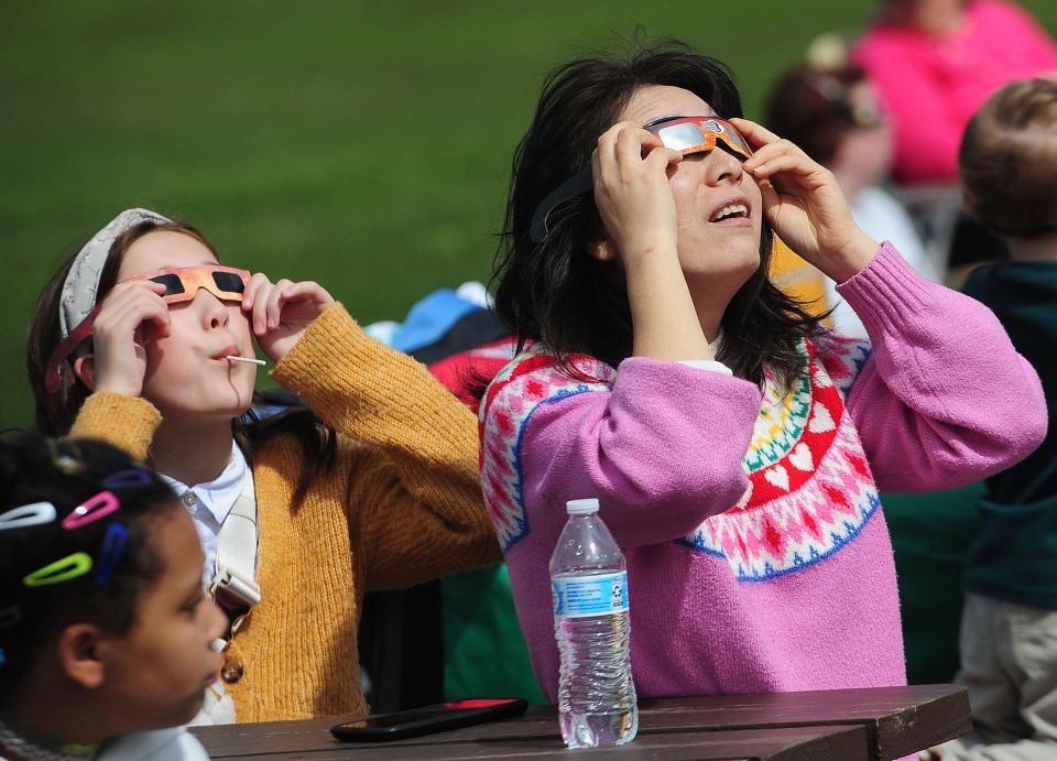 Charlie Hoopes, 10, and Sophia Hoopes view the eclipse Monday, April 8, 2024, during The Total Solar Eclipse Watch Party at Butler Rodman Park in Alliance.