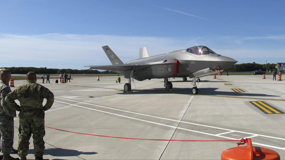 National Guard members, left, view the first two F-35 fighter jets that arrived on Thursday, Sept. 19, 2019, at the Vermont Air National Guard base in South Burlington, Vt., after they were flown by guard pilots from the factory in Fort Worth, Texas. The Vermont Air National Guard is the first guard unit in the country to receive the next-generation fighter. (AP Photo/Wilson Ring)