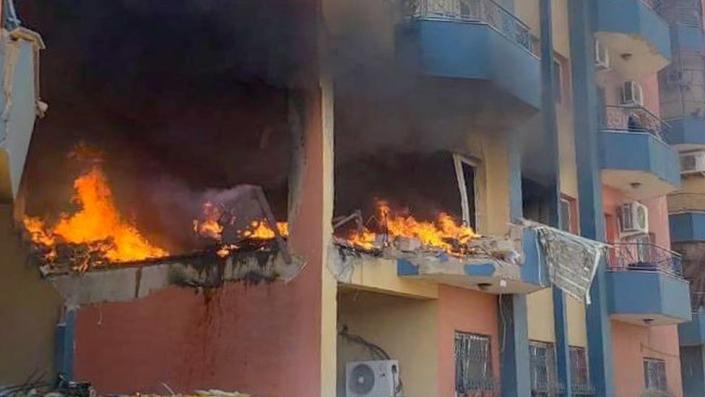 Burning residential building in Khartoum.