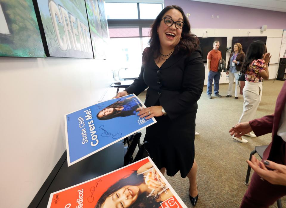 Senate Minority Leader Luz Escamilla, D-Salt Lake City, signs posters during a press conference to announce the expansion of a new State Children’s Health Insurance Program (CHIP) to cover children previously deemed ineligible due to their citizenship status at the Glendale Community Learning Center in Salt Lake City on Wednesday, Oct. 4, 2023. Enrollment will begin on Jan. 1, 2024. | Kristin Murphy, Deseret News