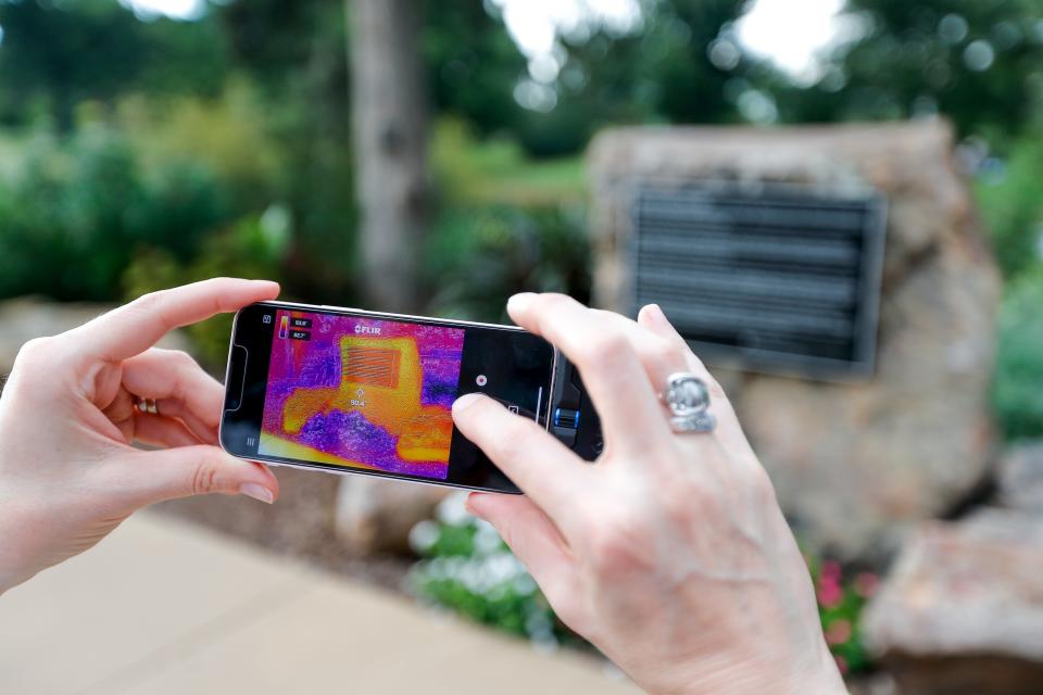 Sarah Terry-Cobo shows a thermal imaging reading of the natural and the built environment Saturday around the Will Rogers Senior Center in Oklahoma City.