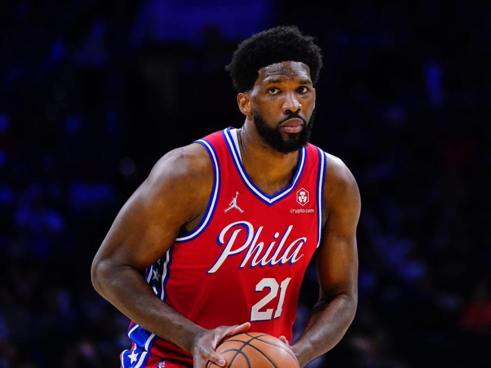 Joel Embiid holds the ball during a game.