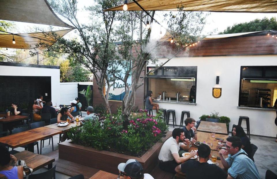 The patio at The Third Place Global Eatery features misters, shade, a waterfall and bar service by Clovis-based Crow & Wolf Brewing Co.