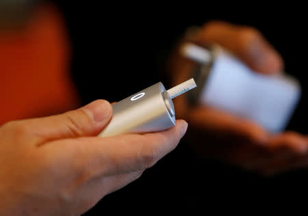 Attendees try British American Tobacco's new tobacco heating system device 'glo' after a news conference in Tokyo, Japan, November 8, 2016. REUTERS/Kim Kyung-Hoon