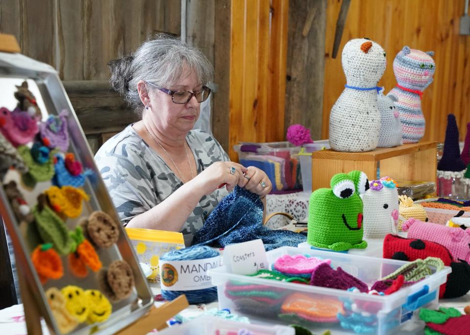 Vendor Amy Cottrill of Adrian works on her knitting in May 20, 2022, at the Farmers Antique Tractor & Engine Association's spring show.