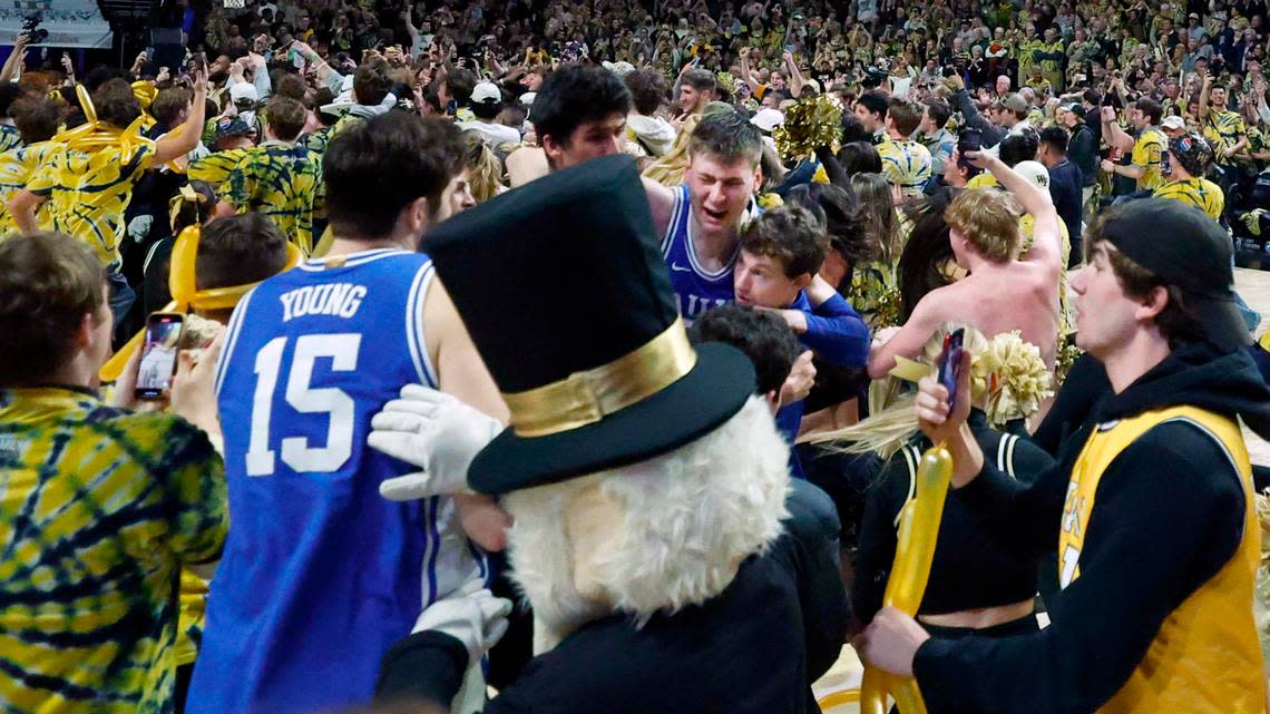 Duke’s Kyle Filipowski (30) is helped off the court after the Wake Forest fans rushed the court after Wake Forest’s 83-79 victory over Duke at Lawrence Joel Veterans Memorial Coliseum in Winston-Salem, N.C., Saturday, Feb. 24, 2024.