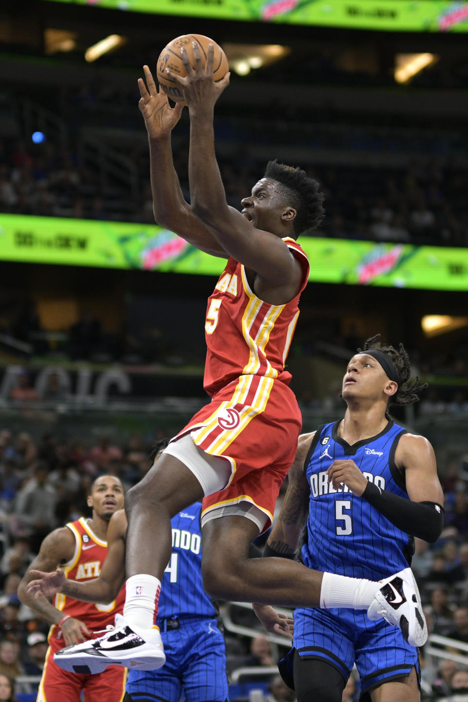 Atlanta Hawks center Clint Capela goes up for a shot in front of Orlando Magic forward Paolo Banchero (5) during the first half of an NBA basketball game Wednesday, Nov. 30, 2022, in Orlando, Fla. (AP Photo/Phelan M. Ebenhack)