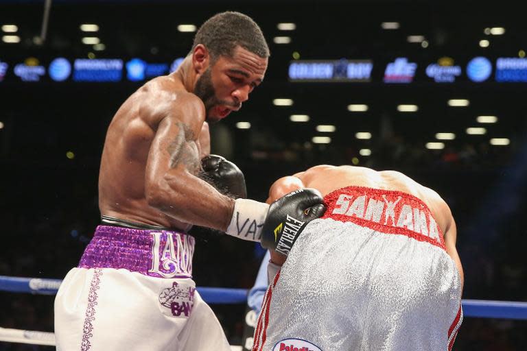 Lamont Peterson (L) lands a body shot to Edgar Santana during their IBF junior welterweight championship fight at the Barclays Center on August 9, 2014 in Brooklyn, New York