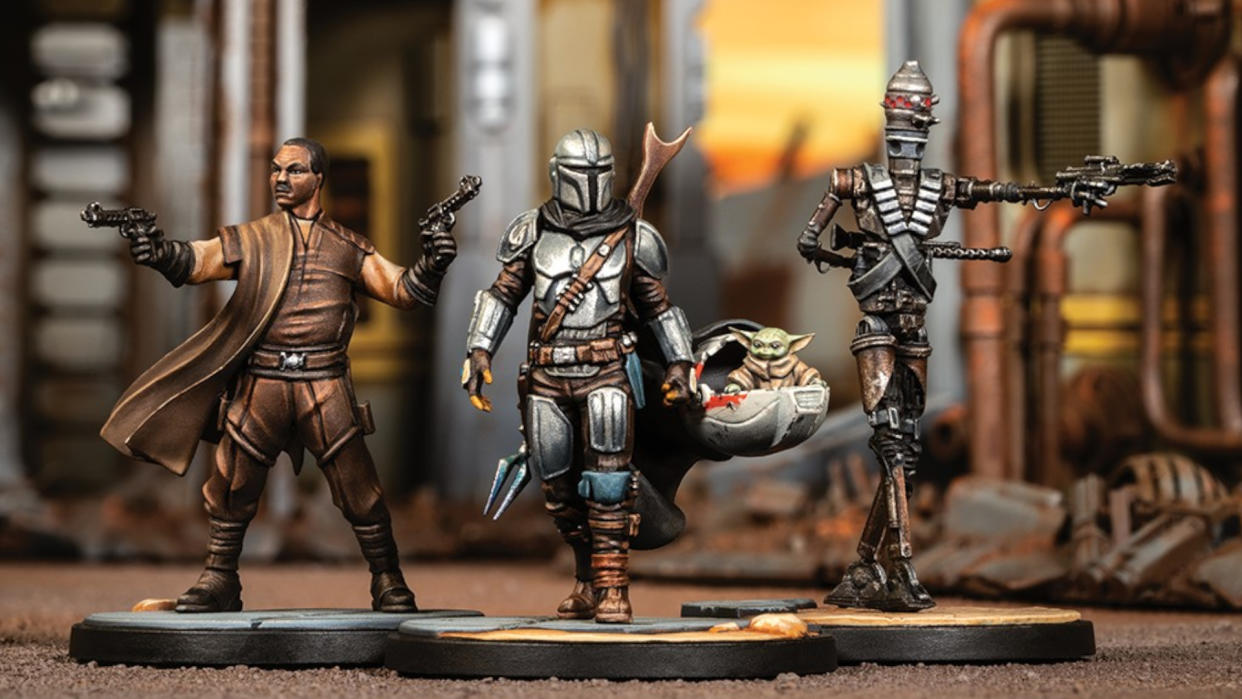  The Mandalorian, Grogu, Greef Karga, and IG-11 models on a Star Wars: Shatterpoint battlefield. 