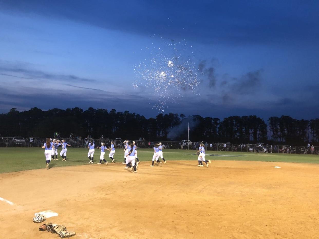 The South Lake High School softball team celebrate as fireworks go off after the Eagles beat New Port Richey River Ridge 4-2 Thursday in the Class 4A-Region 2 championship game at the Eagles Nest in Groveland.