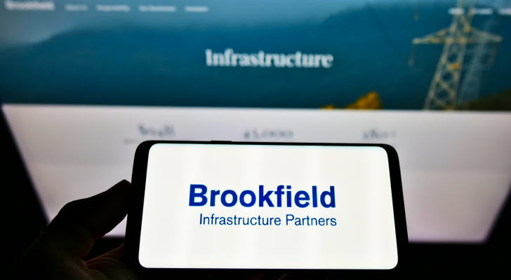 Brookfield Infrastructure logo on a phone screen in front of a blurred computer screen. BIPC stock.