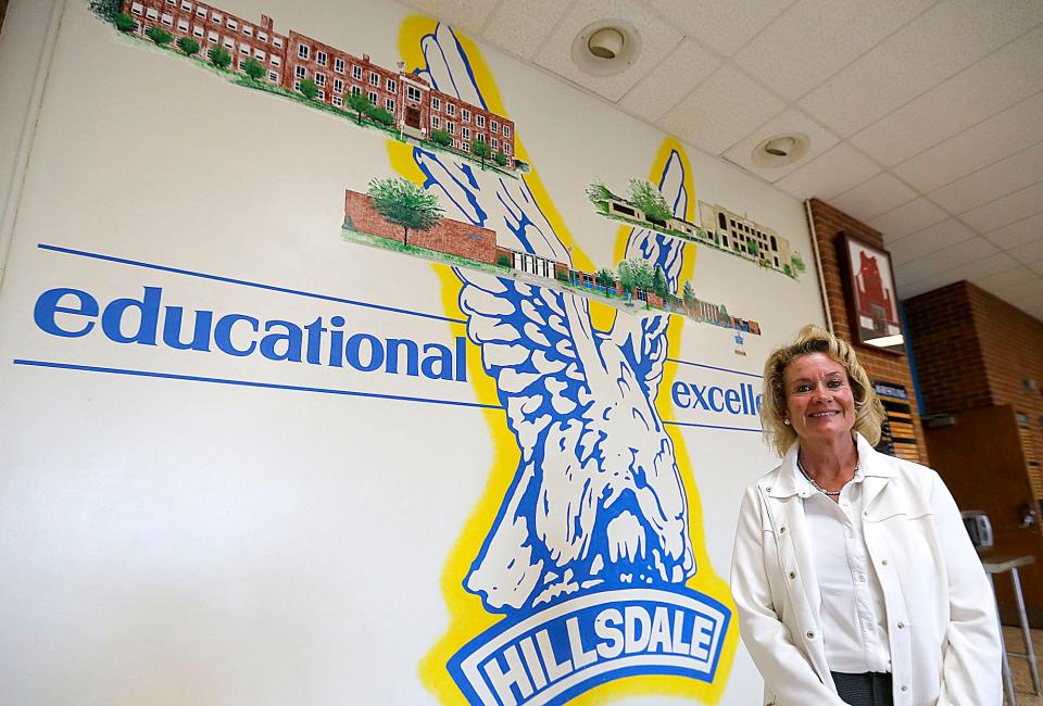 Hillsdale Local Schools' new Superintendent Catherine Trevathan poses in front of the mural in the high school commons area.