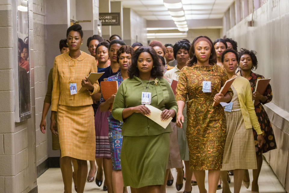 Octavia Spencer walks down the hall followed by a lot of women