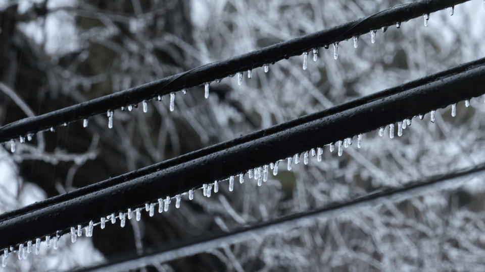 Ice forms on utility lines as temperatures hover around freezing in Detroit, Monday, Feb. 27, 2023. Some Michigan residents faced a fourth straight day without power as crews worked to restore electricity to more than 165,000 homes and businesses in the Detroit area after last week's ice storm. (AP Photo/Paul Sancya)