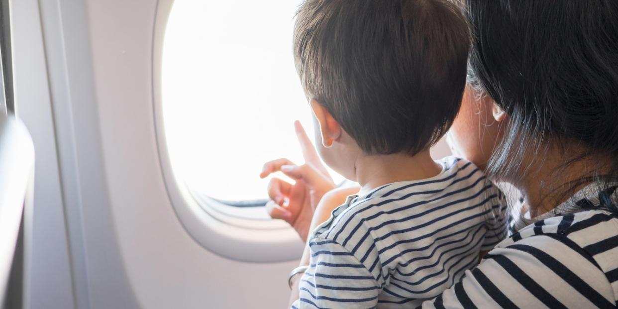 mom and toddler on airplane airplane activities for kids painters tape