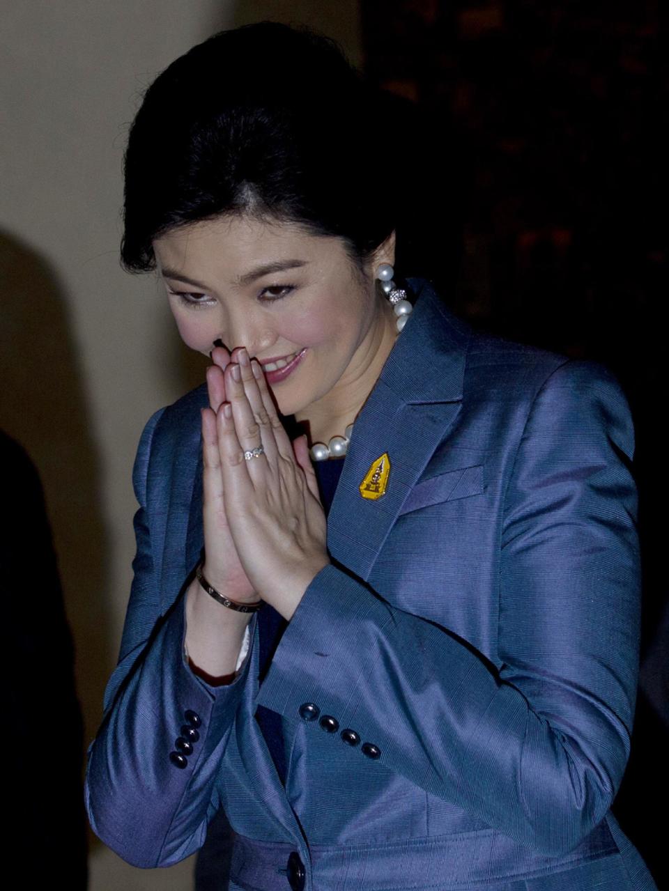 Thailand's Prime Minister Yingluck Shinawatra arrives at the Constitutional Court in Bangkok, Thailand, Tuesday, May 6, 2014. Yingluck defended herself Tuesday against abuse of power allegations in a crucial court case that is one of several legal challenges which could remove her from office. She is accused of abusing her authority by transferring her National Security Council chief in 2011 to another position. (AP Photo/Sakchai Lalit)