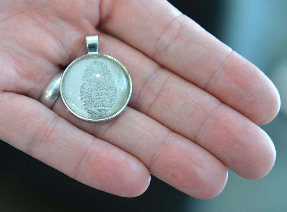 Paul Alexander, step-father of Lilly Glaubach, carries a pendant of Lilly's fingerprint. 