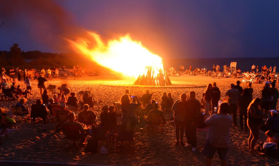Winds blow the giant bonfire on Presque Isle State Park's Beach 11 during the 2021 Discover Presque Isle.