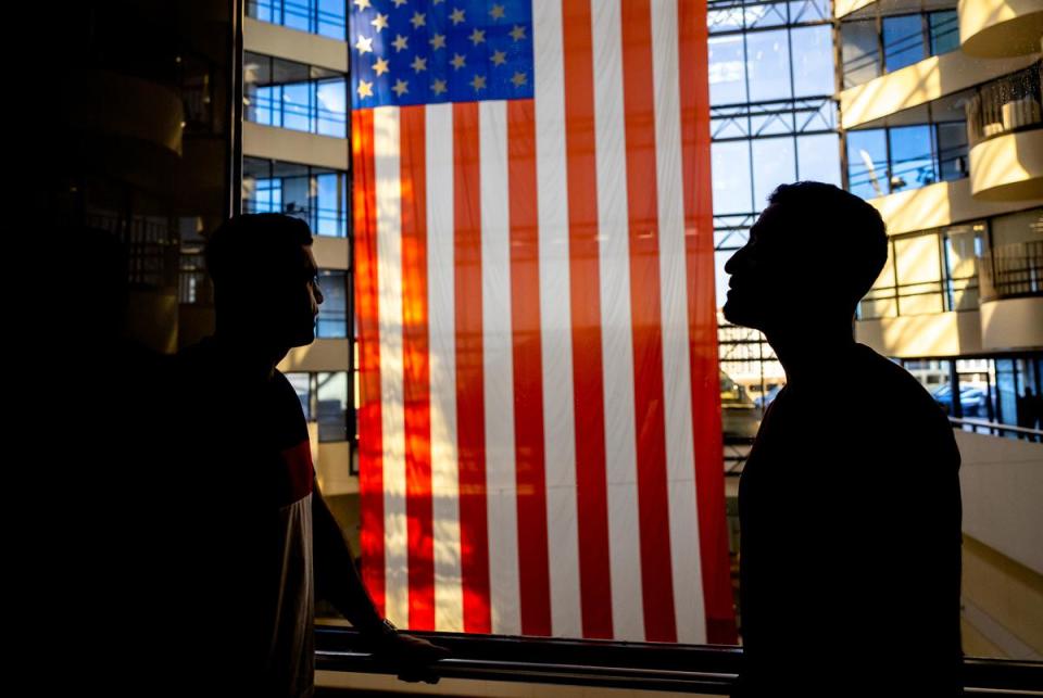 Sami-ullah Safi and his Abdul Wasi Safi ride an elevator at the Galleria Mall in Houston on Feb. 2, 2023.