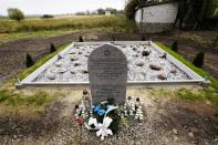 Candles and a wreath pay tribute to some 60 Jews executed in the town during the Holocaust at a new memorial dedicated in Wojslawice, Poland, on Thursday Oct. 14, 2021. It is one of many mass grave sites to be discovered in recent years in Poland, which during World War II was occupied by Adolf Hitler’s forces. (AP Photo/Czarek Sokolowski)