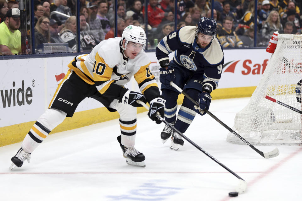 Pittsburgh Penguins forward Drew O'Connor (10) controls the puck in front of Columbus Blue Jackets defenseman Ivan Provorov during the first period of an NHL hockey game in Columbus, Ohio, Saturday, March 30, 2024. (AP Photo/Paul Vernon)