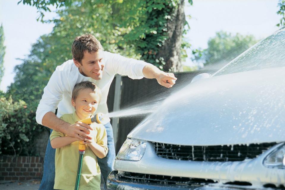 son helping his father to wash the car