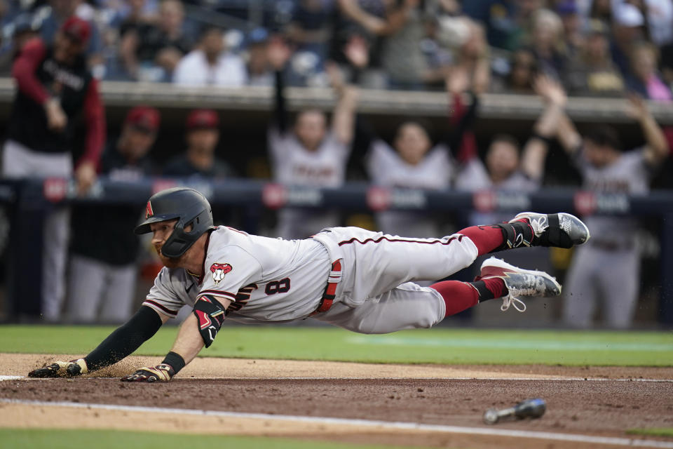 Arizona Diamondbacks' Jordan Luplow slides into home, scoring on a two-run, in the park home run during the third inning of a baseball game against the San Diego Padres, Tuesday, June 21, 2022, in San Diego. (AP Photo/Gregory Bull)