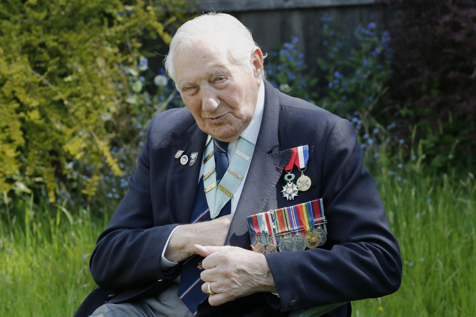 World War II Veteran Mervyn Kersh poses for a photo at his house in London, Monday, May 4, 2020. On Friday's 75th anniversary of the end of World War II in Europe, talk of war is afoot again — this time against a disease that has killed at least a quarter of a million people worldwide. Instead of parades, remembrances and one last great hurrah for veterans now mostly in their nineties, it is a time of lockdown and loneliness, with memories bitter and sweet (AP Photo/Frank Augstein)