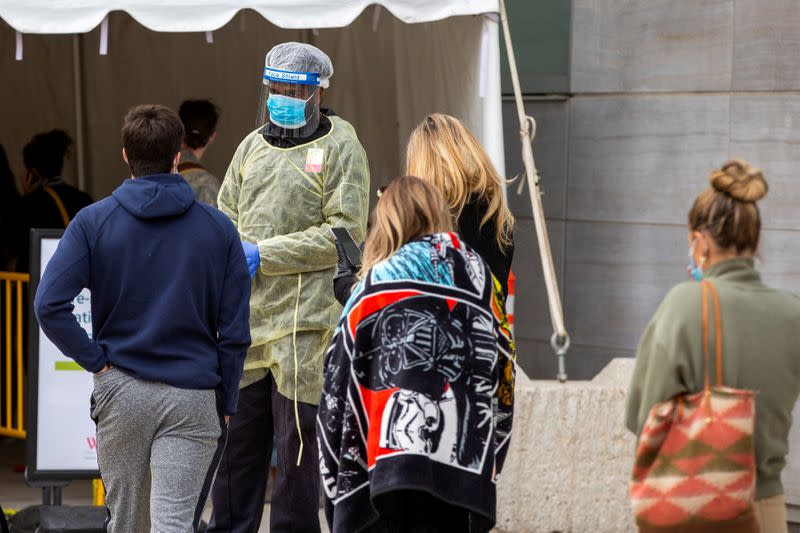 FILE PHOTO: People wait in line at a coronavirus disease (COVID-19) testing facility in Toronto.