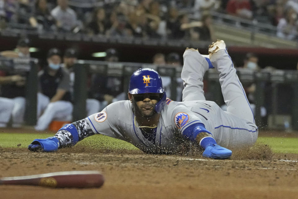 New York Mets' Jonathan Villar scores on a triple by Francisco Lindor during the sixth inning of the team's baseball game against the Arizona Diamondbacks, Tuesday, June 1, 2021, in Phoenix. (AP Photo/Rick Scuteri)