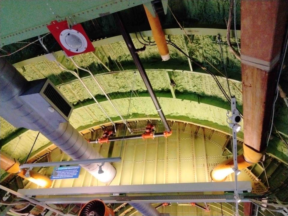 archway of an airplane showing green foam-like material and struts