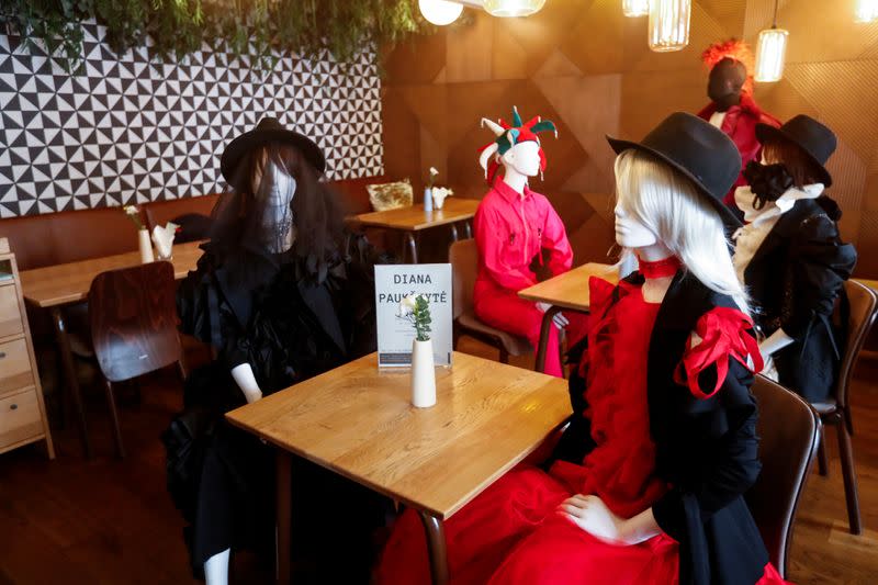 Mannequins dressed in creations of local designer sit at the table in a restaurant during the coronavirus disease (COVID-19) outbreak in Vilnius