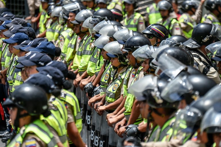 Members of the National Police close ranks near a demonstration of Venezuela's opposition in Caracas on July 27, 2016