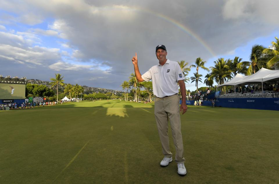 HONOLULU, HI - JANUARY 13: Matt Kuchar points to a rainbow over the 18th hole after winning the Sony Open in Hawaii at Waialae Country Club on January 13, 2019 in Honolulu, Hawaii. (Photo by Stan Badz/PGA TOUR)